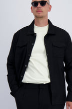 Luxury wool tech overshirt with buttons and chest pockets in black. Crafted with premium fabrics. A timeless design mens wear